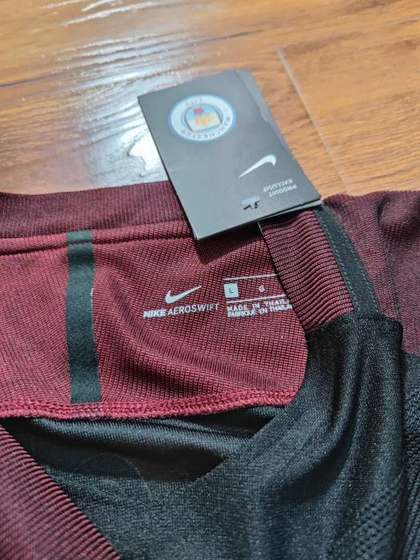 Manchester City jersey collar and Nike Aeroswift tag detail